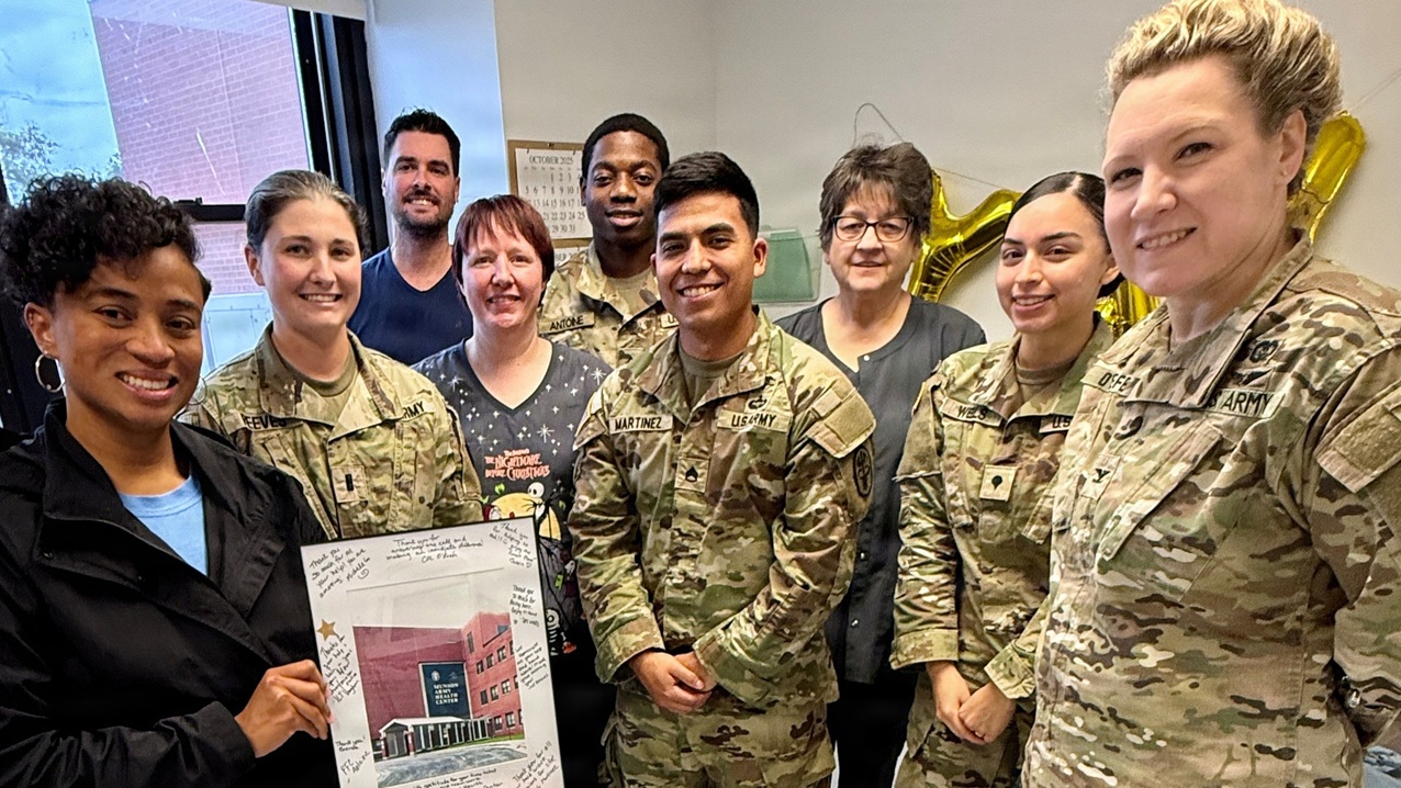 Munson Army Health Center Deputy Commander for Nursing Col. Gwendolyn O’Keefe, right, and Department of Public Health staff, recognized Carl R. Darnall Army Medical Center Occupational Health Nurse Stephanie Manogin, left, with a token of appreciation, Oct. 29. Manogin traveled to Munson to provide essential occupational health support ensuring the Fort Leavenworth team stays missions ready.