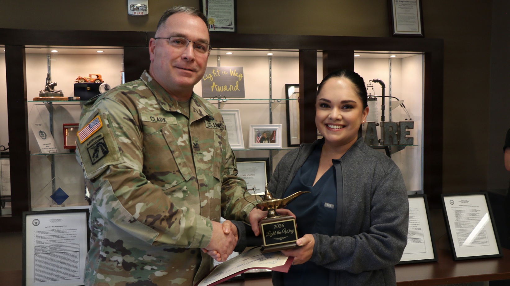 U.S. Army Col. Richard Clark, chief nursing officer at William Beaumont Army Medical Center, presents Arianna Bordanada, vascular access registered nurse at WBAMC, with the WBAMC Light The Way Nurse Award on Jan. 15, 2026, at the main campus of the hospital.