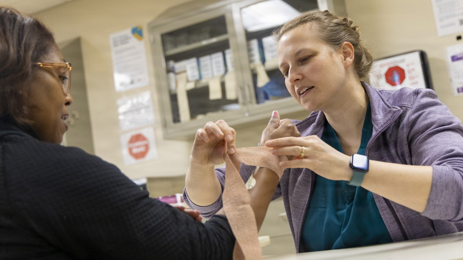 An occupational therapist wraps a patient's wrist