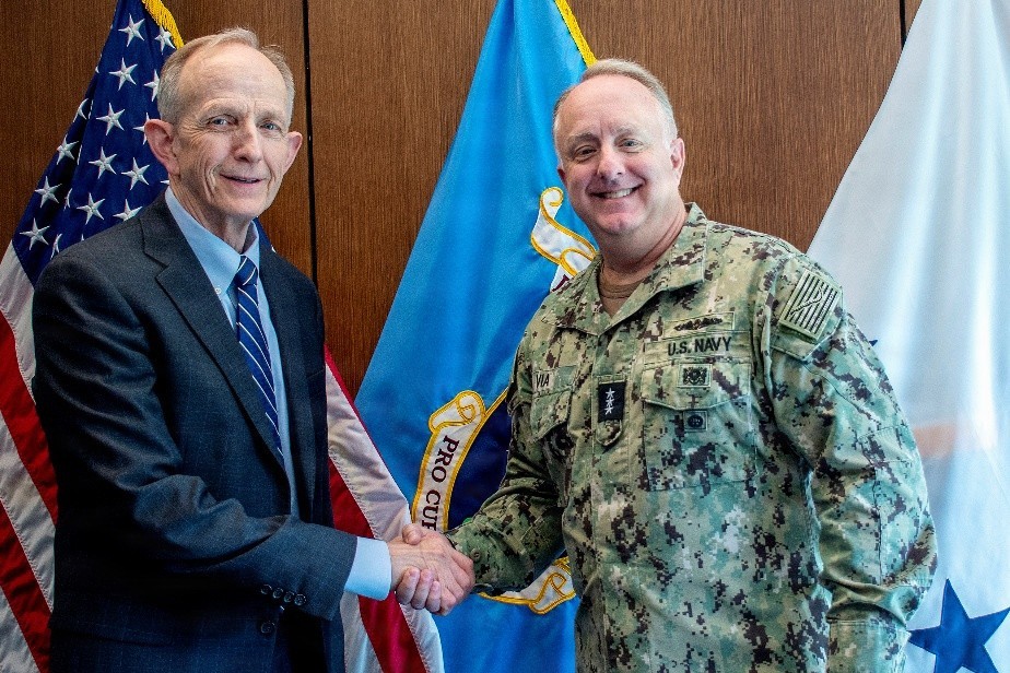 Defense Health Agency Director Vice Adm. Darin Via (right) greets Dr. David Smith, newly appointed DHA deputy director, after Smith is sworn into office, at the Defense Health Headquarters, Falls Church, Virginia, April 6, 2026.