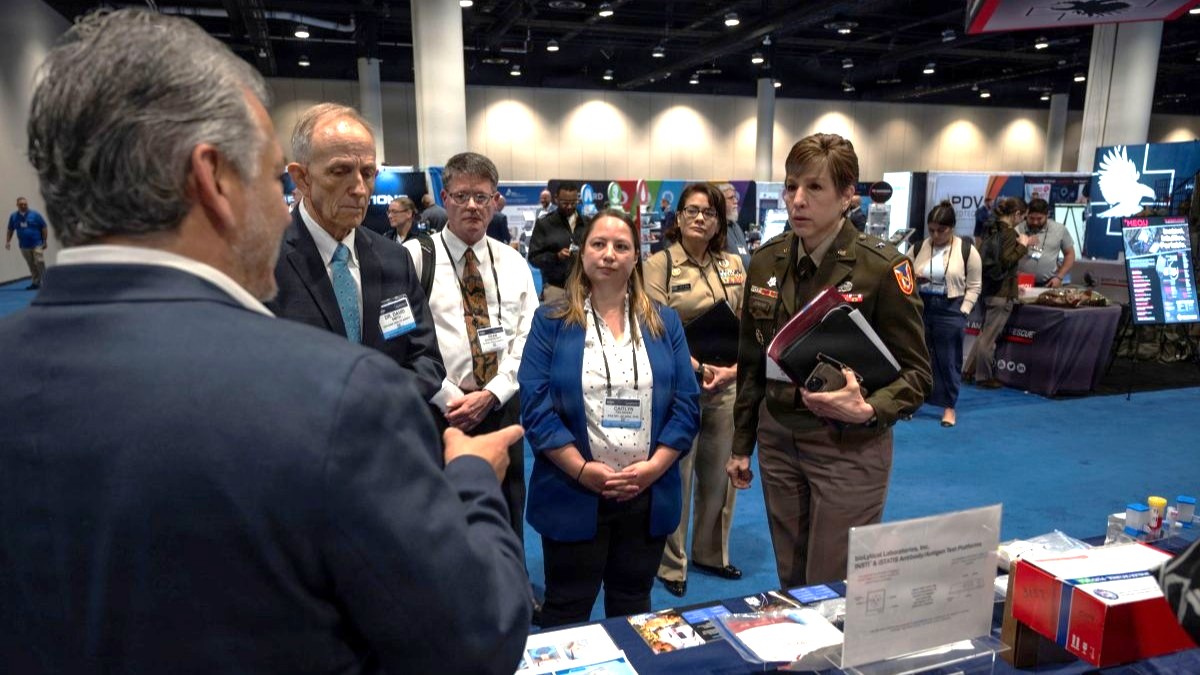 Senior leaders with the Defense Health Agency tour the Research, Development, and Acquisition/Component Acquisition Executive office (AD-RDA/CAE) display during the Military Health System Research Symposium, Kissimmee, Florida, Aug. 4, 2026. MHSRS is the premier military meeting that focuses specifically on the unique medical needs of the deployed Warfighter. The symposium provides a venue for presenting new scientific knowledge resulting from military-unique research and development. (Defense Health Agency Photo by Cameron E. Parks/Released)