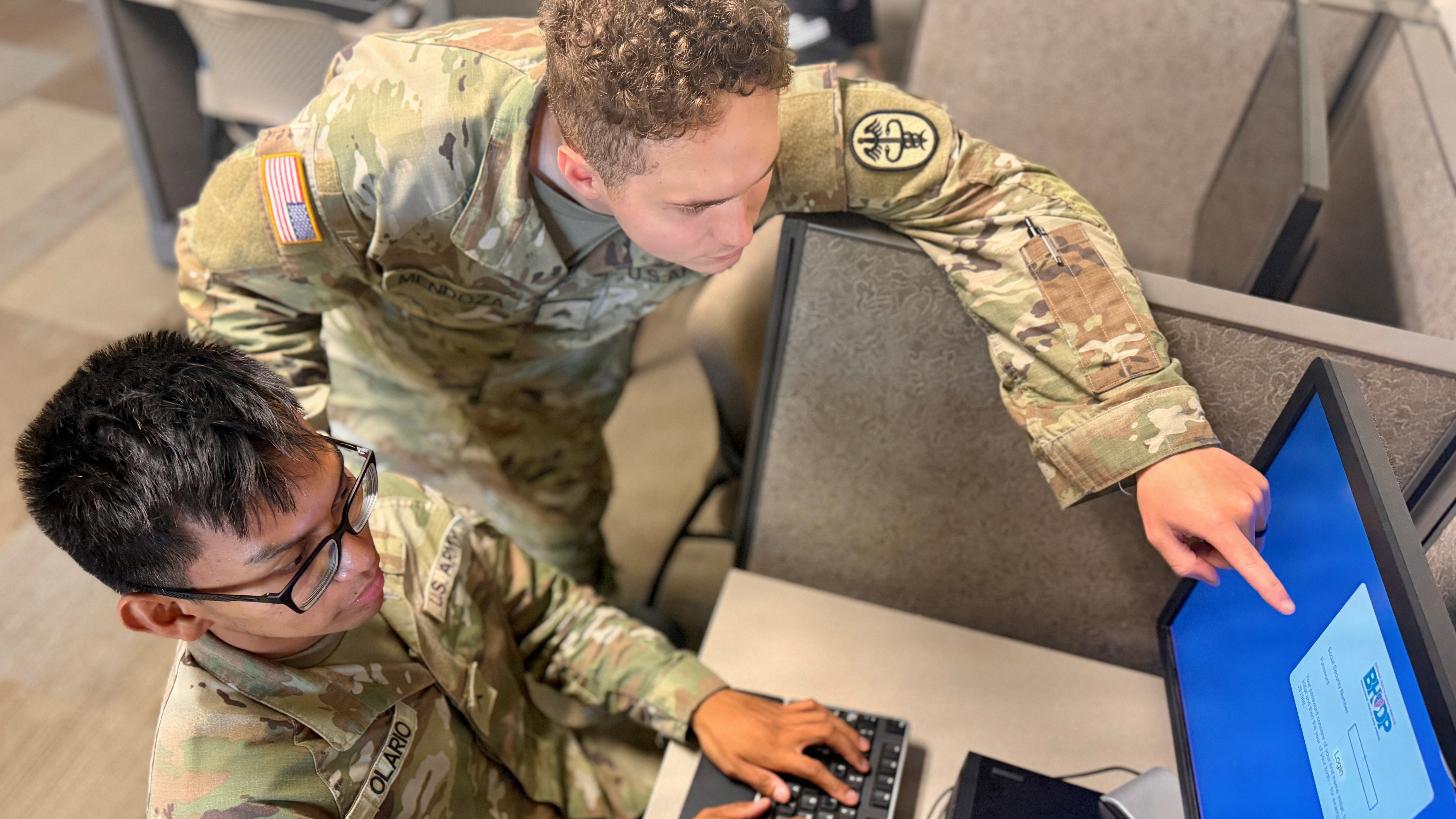 Sgt. Alberto Mendoza, a mental health specialist assigned to Bayne-Jones Army Community Hospital, assists Pvt. Juno Olario with logging into the Behavioral Health Data Portal during a simulated Targeted Care intake Aug. 20 at the 3rd Brigade, 10th Mountain Division Embedded Mental Health Clinic at the Joint Readiness Training Center and Fort Polk, Louisiana. The secure, web-based portal allows patients to complete standardized assessments that help mental health providers evaluate symptoms and inform clinical decisions.