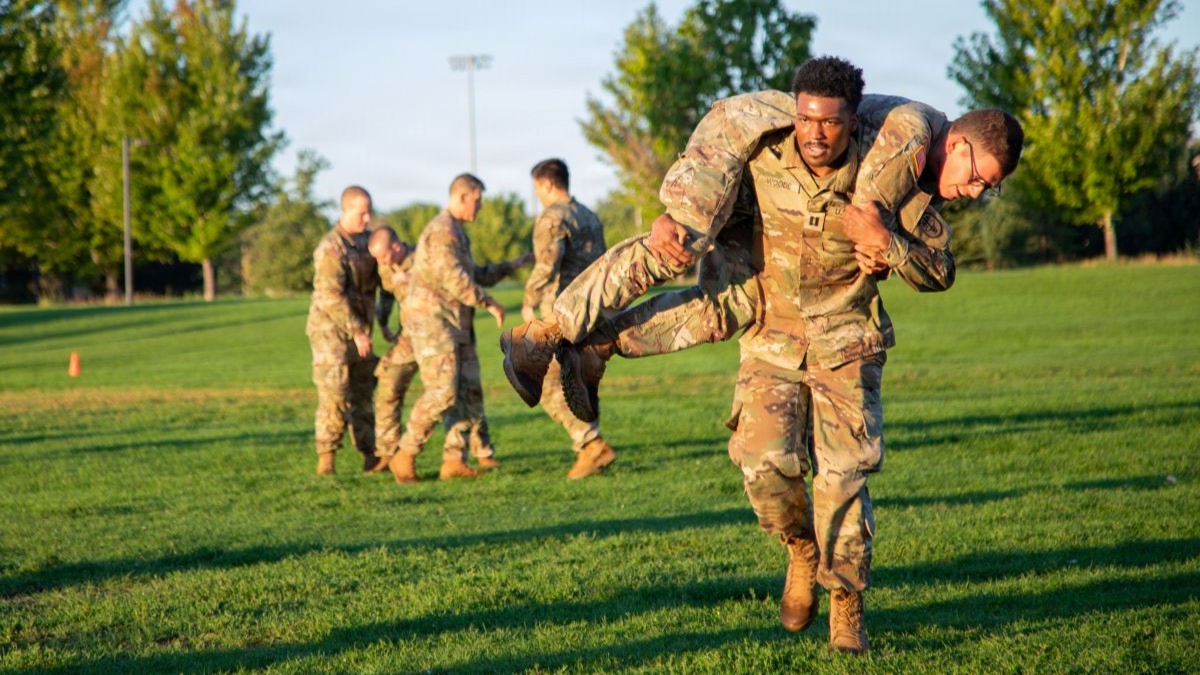 Soldiers assigned to the 4th Infantry Division and other tenant units conduct battle buddy carries during a newcomers physical training event on Fort Carson, Colorado, August 26, 2026. The exercise tested teamwork, endurance and the ability to move effectively under physical stress. (U.S. Army photo by Pfc. Jacob Cruz)