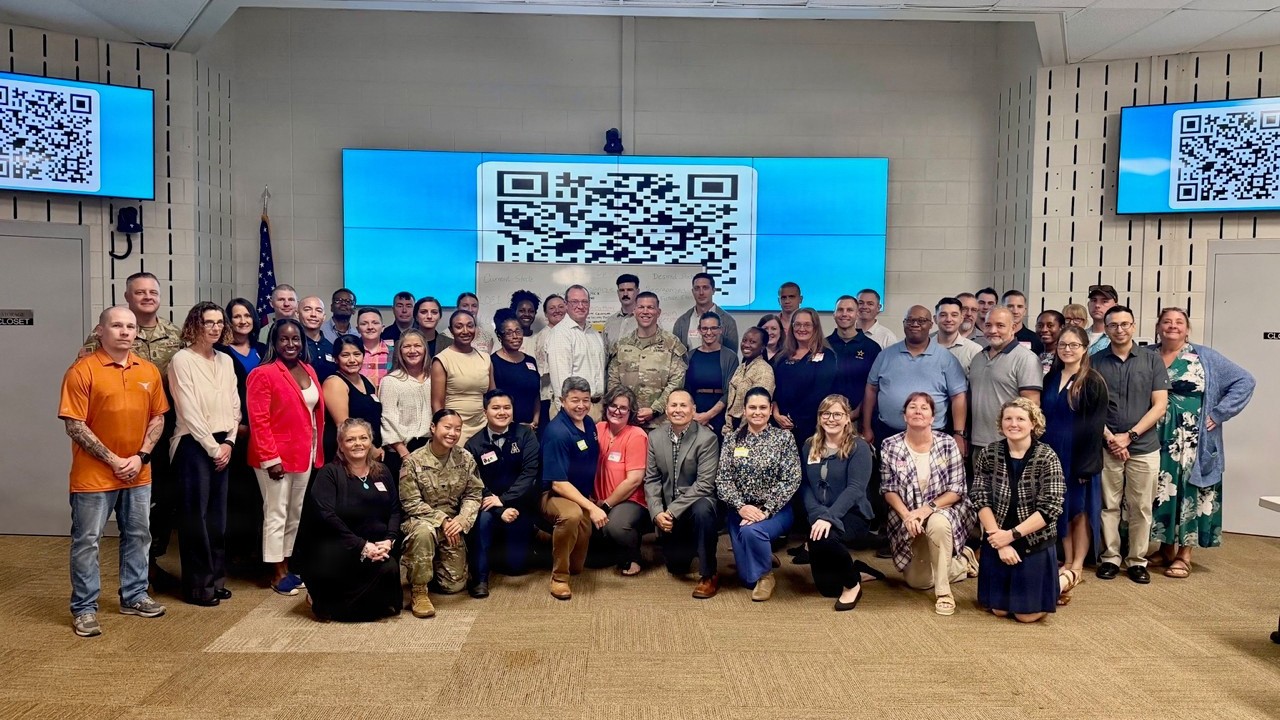 More than 50 military and civilian leaders from Bayne-Jones Army Community Hospital gather for a group photo during the BJACH Design Summit at the Warrior Training Facility at the Joint Readiness Training Center and Fort Polk, Louisiana, Sept. 11, 2026. Facilitated by a team from the U.S. Army War College, the two-day summit brought leaders together across departmental boundaries to examine the hospital’s structure and functions, strengthen communication and collaboration, and develop potential improvements supporting the workforce, patient care and medical readiness.
