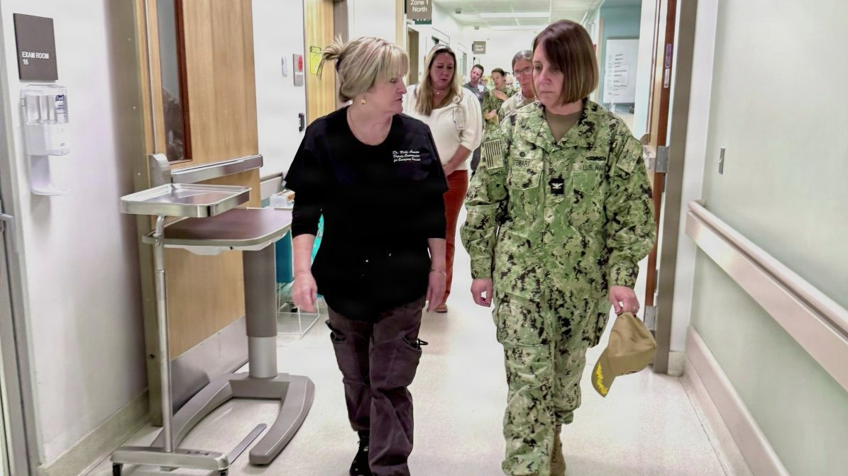 Womack Army Medical Center leaders and staff host Naval Medical Center Camp Lejeune Command team during recent visit. Capt. Kathryn M. Stewart, commander and director of Naval Medical Center Camp Lejeune speaks with Dr. Vicki Lanier, Deputy Commander Emergency Services and Department of Emergency Medicine chief.
