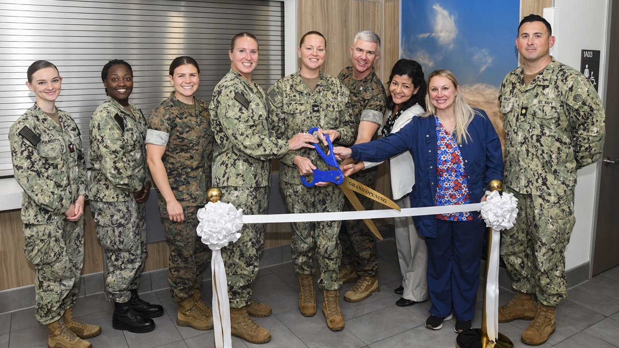 Leadership and clinic staff pose for a photo during the ribbon cutting ceremony for the new branch medical clinic aboard Camp Johnson, on October 22, 2025.