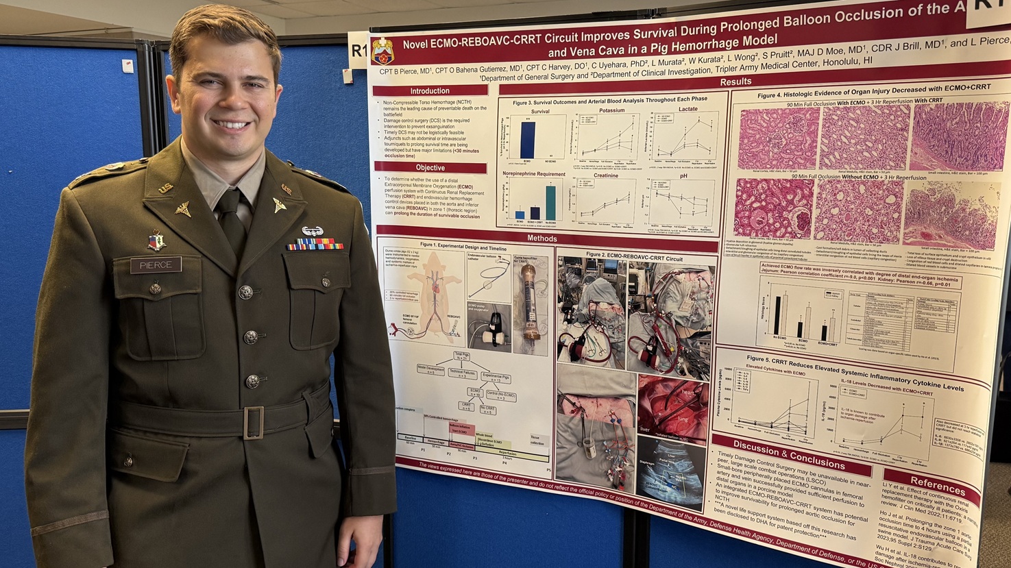 U.S. Army Capt Bradley Pierce, General Surgery Resident Physician at Tripler Army Medical Center, Honolulu, Hi. poses with his research Project on ECMO life support. (Hugh Fleming)