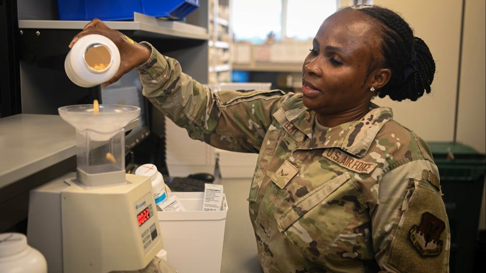 Woman measuring out pills on a scale