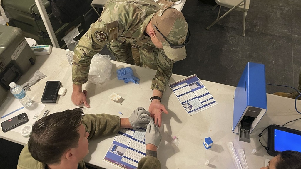U.S. Army Capt. Thomas Pickett, bottom, a physician assistant with the Combat Aviation Brigade, 28th Infantry Division, collects a whole blood sample from U.S. Air Force Maj. William Bennett, top, a physician with 88th Medical Group, during Exercise Balikatan 25 at Fort Magsaysay, Philippines, April 29, 2025.