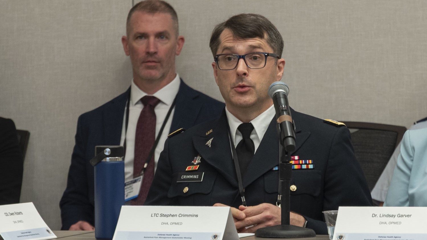 U.S. Army Lt. Col. Stephen Crimmins, a product manager with Operational Medical Systems Warfighter Protection and Acute Care team, briefs attendees of the Military Health System Research Symposium during a Battlefield Pain Management stakeholder meeting, Kissimmee, Florida, Aug. 5, 2025.