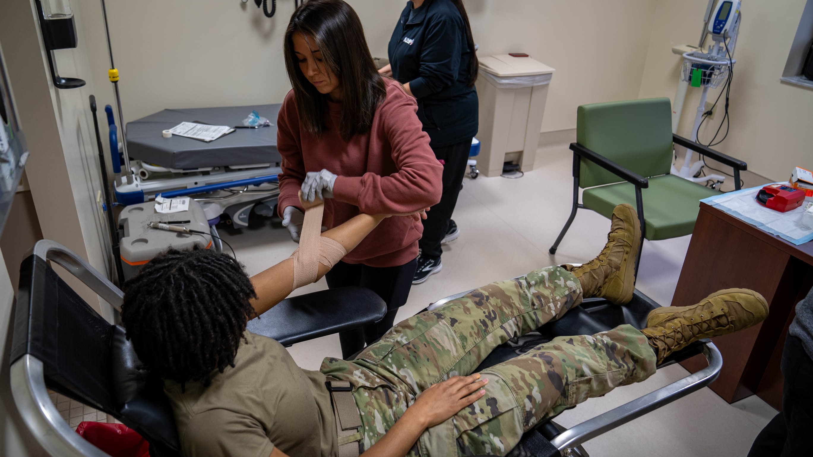 nurse bandages patient's arm after giving blood